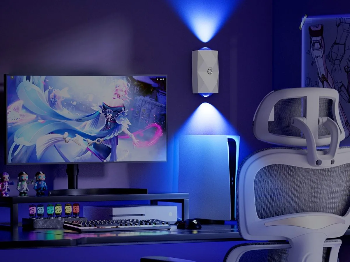 Gaming room setup with ZSYZDL wall light glowing blue behind monitors and an ergonomic chair